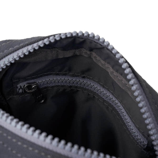 Roka Bond faded black recycled canvas backpack with multiple interior zippered compartments, one-size, durable design.