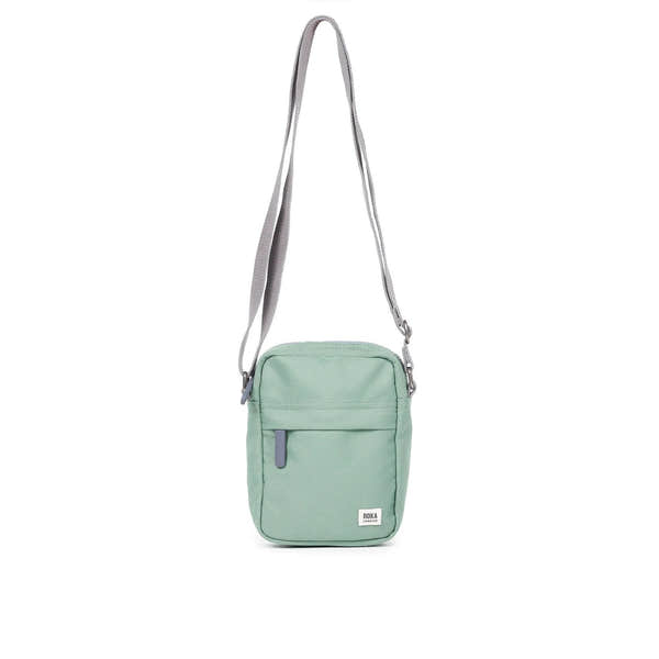 Roka Bond Frost recycled canvas crossbody bag, one size, mint green with gray adjustable strap and front zipper pocket.