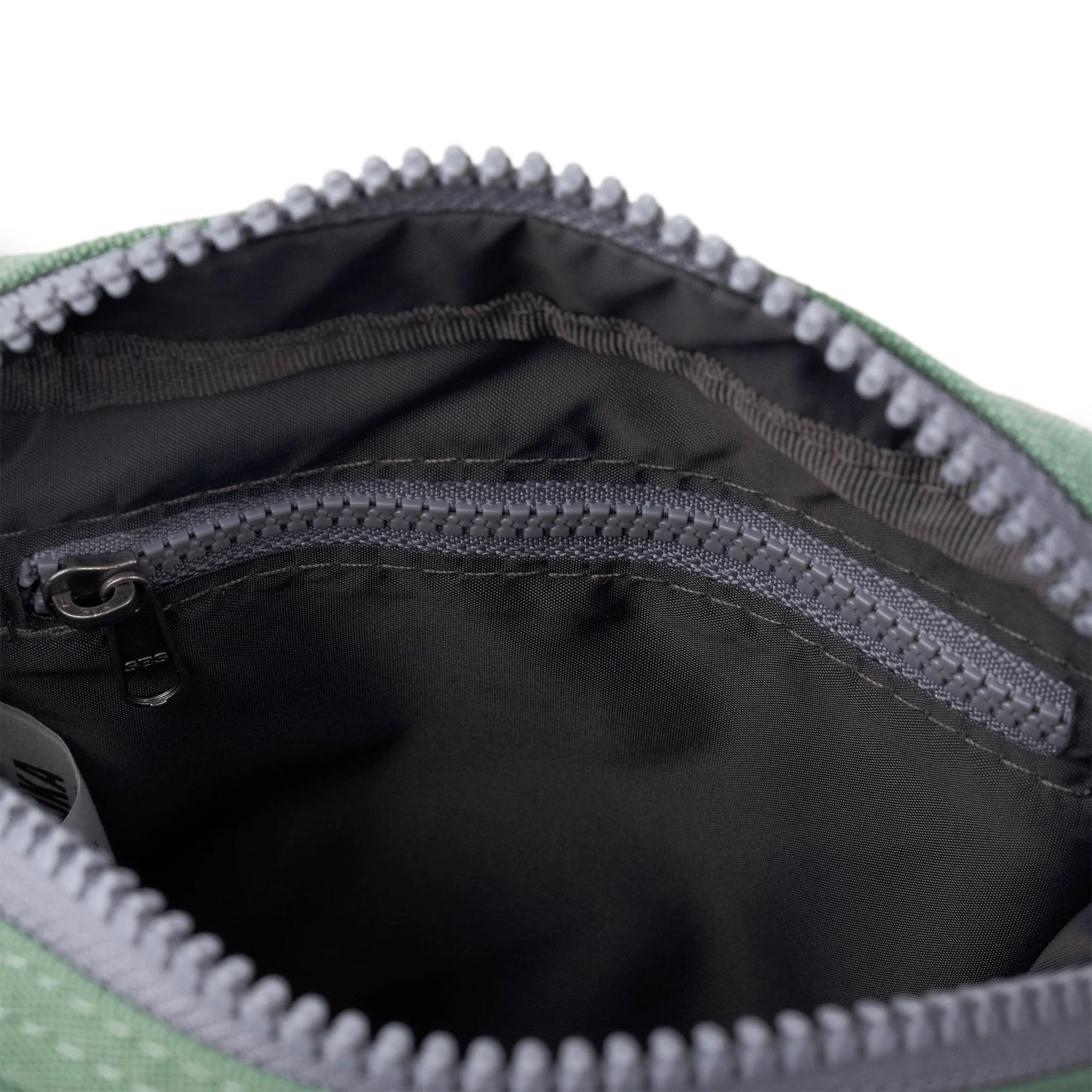 Roka Bond Frost recycled canvas bag interior with zip pocket, black lining, and durable stitching, one size.