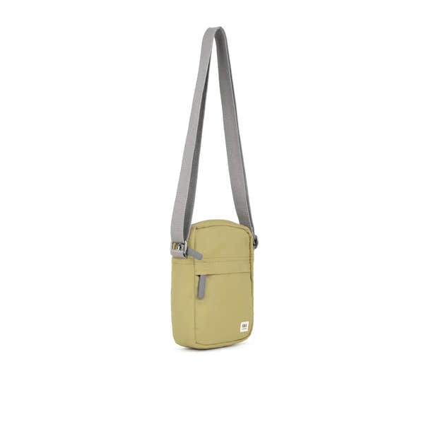 Roka Bond Khaki Recycled Canvas Crossbody Bag, one size, with adjustable gray strap and front zip pocket.