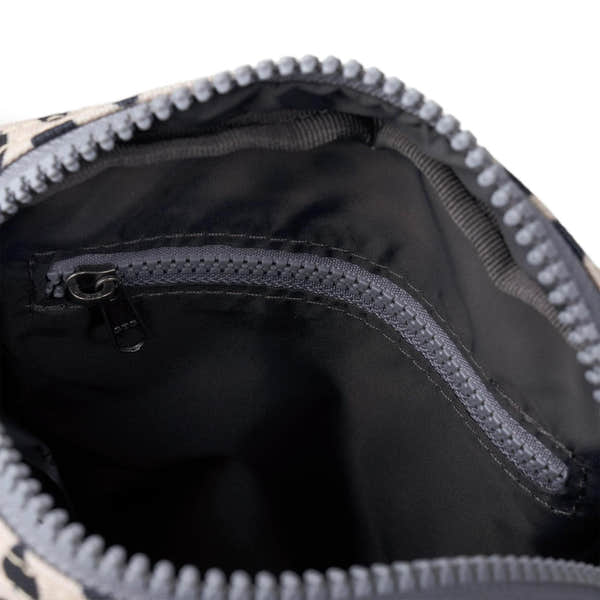Interior view of Roka Bond linear dot recycled canvas bag with zippered pocket and black lining.