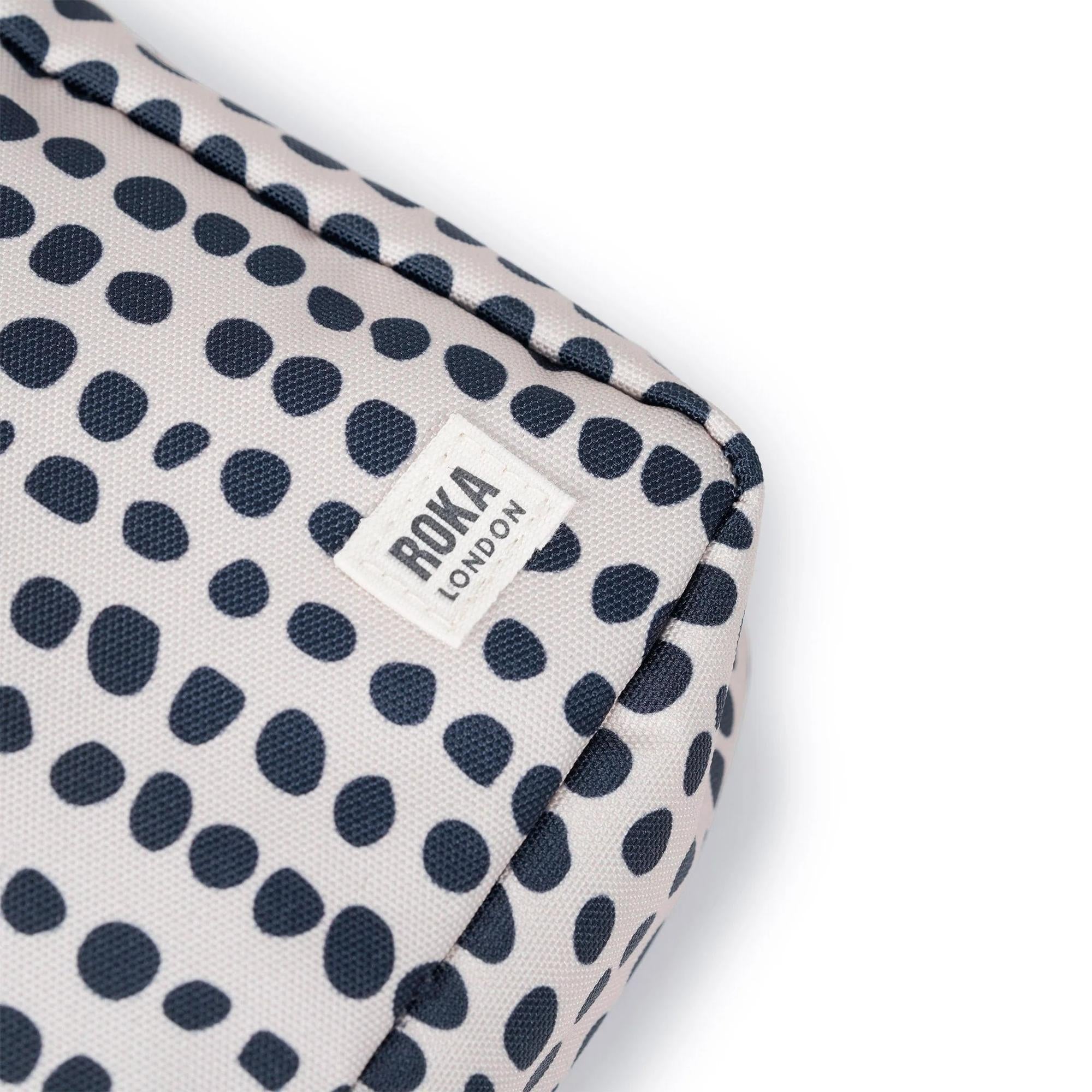 Roka Bond linear dot recycled canvas bag, one size, navy and white polka dot pattern, brand label detail.