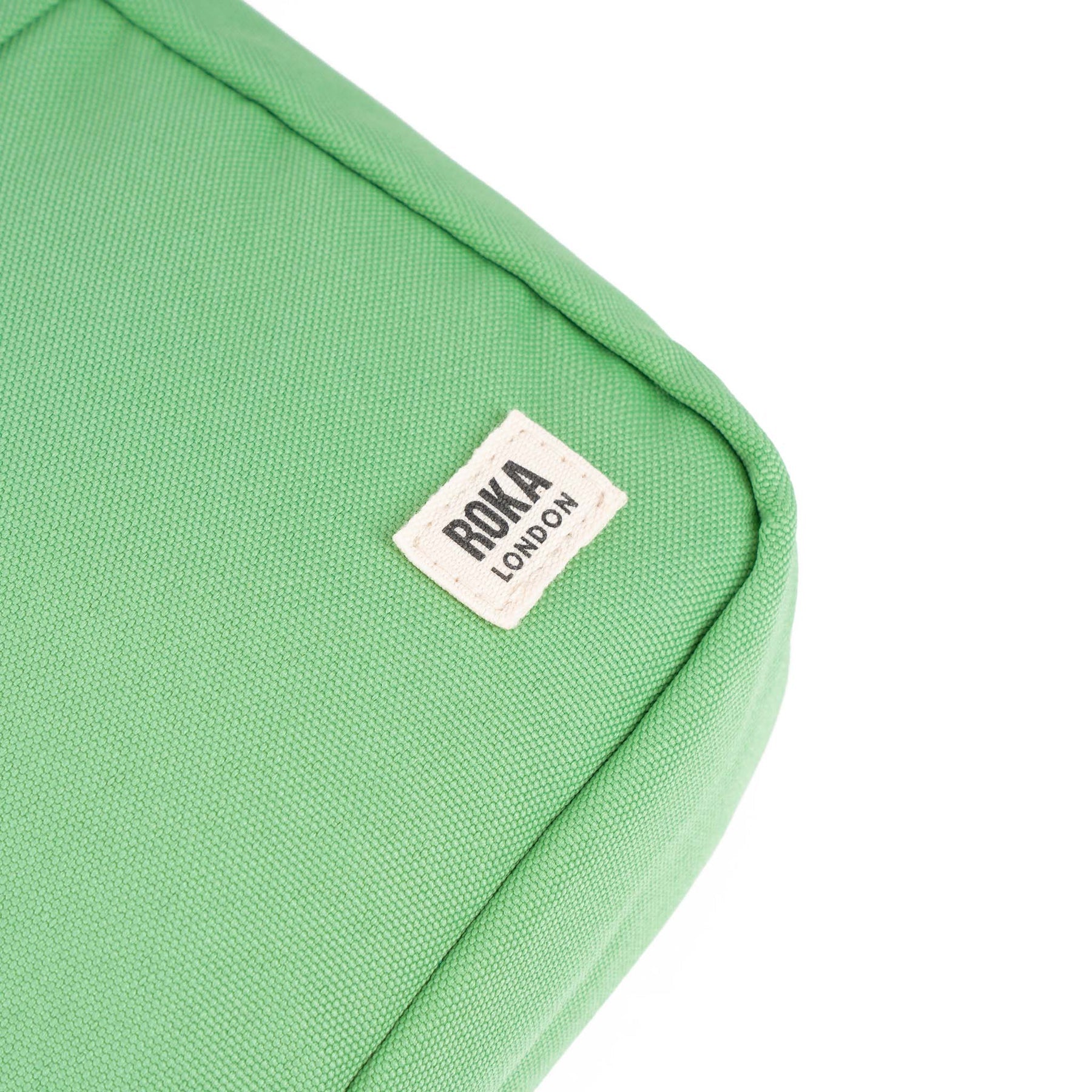 Roka Bond Recycled Canvas Peppermint tote bag in vibrant green with stitched label detail. Eco-friendly and stylish accessory.