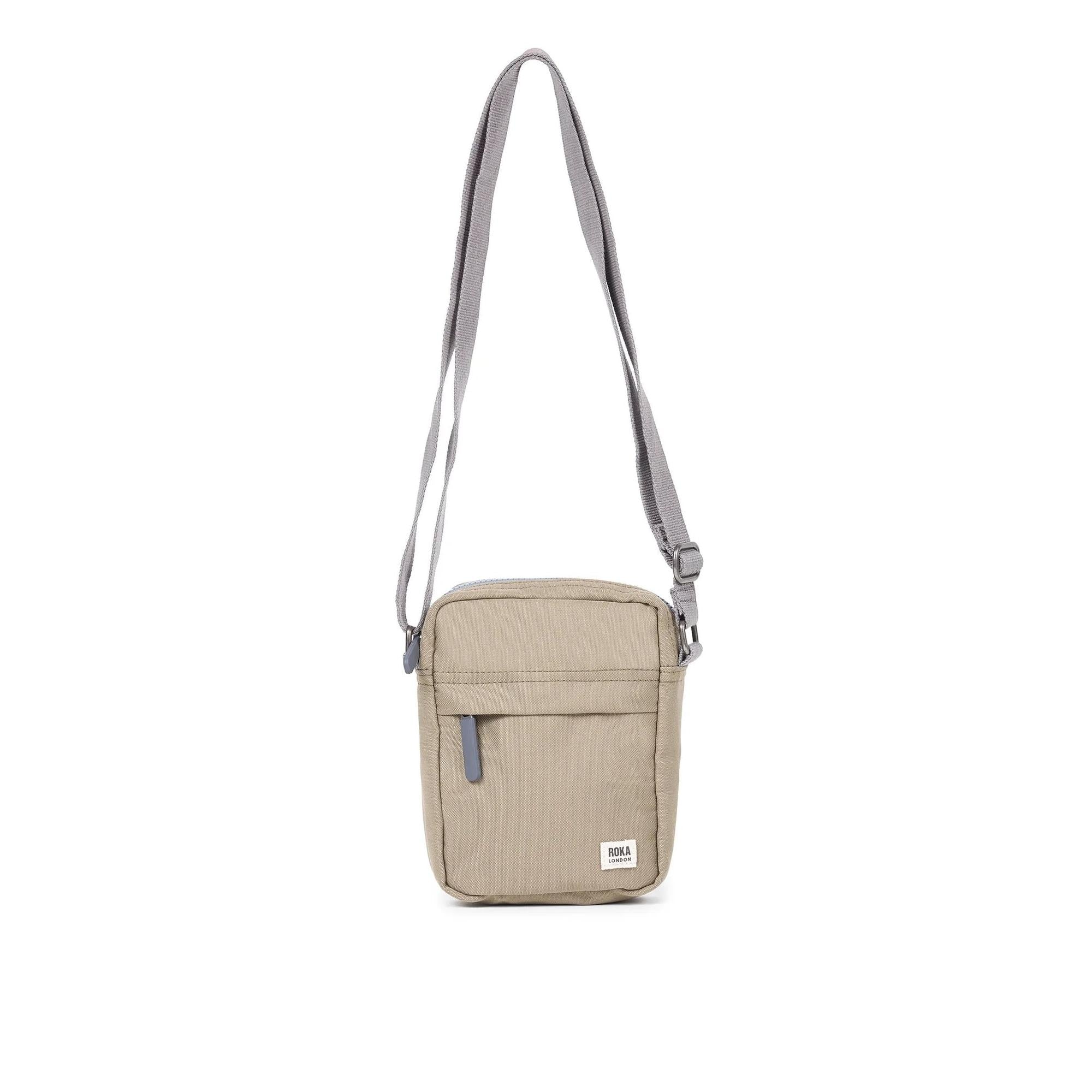 Roka Bond Taupe recycled canvas crossbody bag with adjustable strap and front zipper pocket, one size.