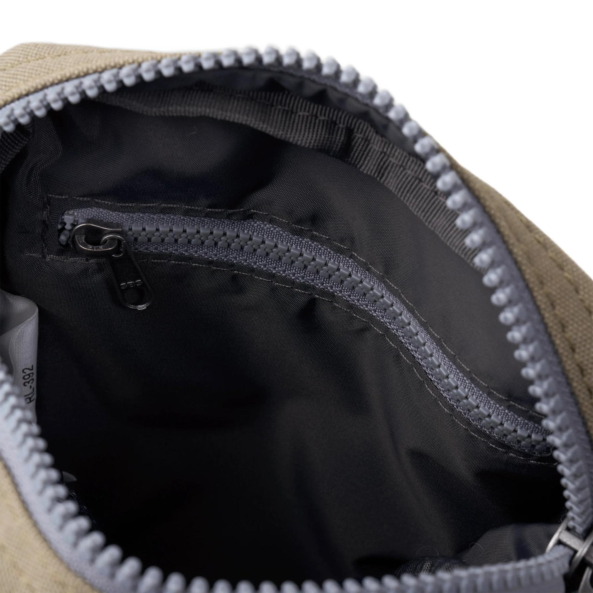 Roka Bond Taupe Recycled Canvas backpack interior with black lining and zippered pocket, one size.