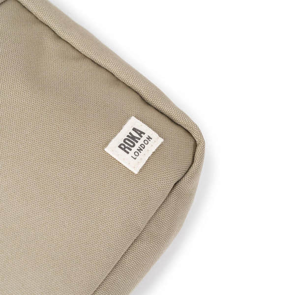 Roka Bond Taupe Recycled Canvas Bag, one size, minimal design, close-up of brand label on textured taupe fabric.