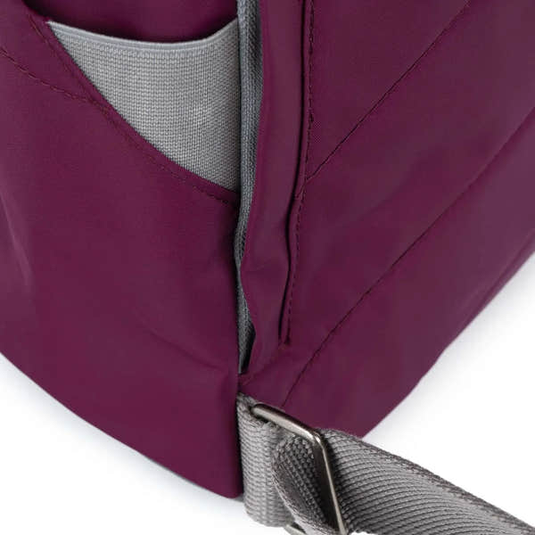 Roka Canfield B Royal Burgundy recycled nylon bag with grey strap, close-up of zipper and stitching details.