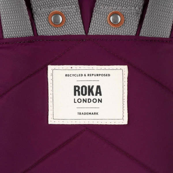 Roka Canfield B Royal Burgundy recycled nylon bag with gray straps and metal eyelets, featuring a white label.