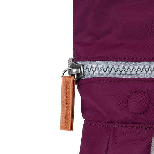 Roka Canfield B Royal Burgundy recycled nylon backpack with silver zipper and tan leather pull tab.