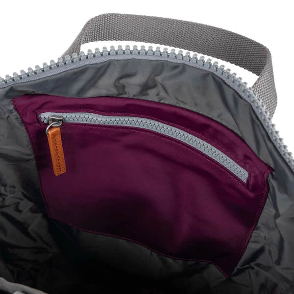 Roka Canfield B Royal Burgundy recycled nylon interior of a tote bag with zippered pocket and gray fabric handle.