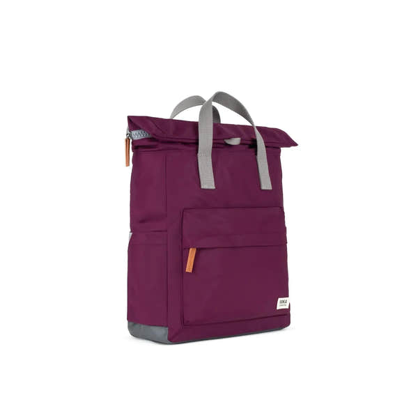Roka Canfield B Royal Burgundy recycled nylon backpack with gray handles and orange zipper accents.