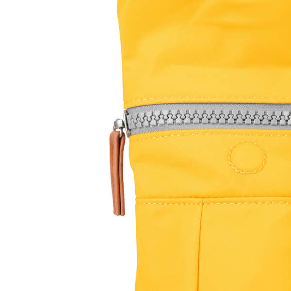 Roka Canfield B Saffron reusable bag made from recycled nylon, featuring a silver zipper and tan leather zipper pull.