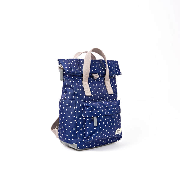 Roka Canfield Small Navy Polka Dot Recycled Canvas Backpack, side view.