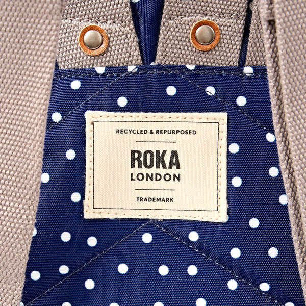 Roka Canfield Small Navy Polka Dot Recycled Canvas Backpack, brand label detail.