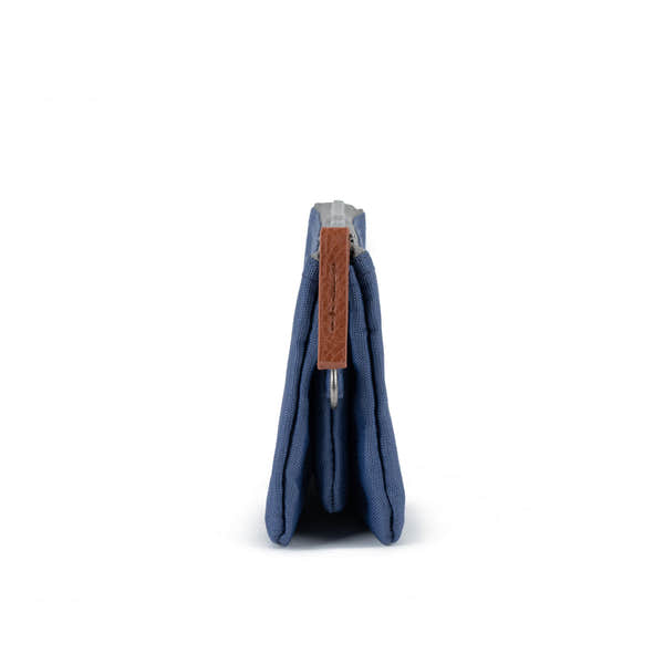 Roka Carnaby Burnt Blue Recycled Canvas wallet, side view, featuring brown leather zipper pull and compact design.