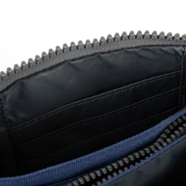 Roka Carnaby burnt blue recycled canvas backpack interior with zippered pocket and multiple card slots.