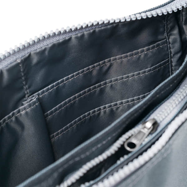 Roka Carnaby Crossbody Smoke XL bag with recycled canvas interior, multiple compartments, and zipper closure.