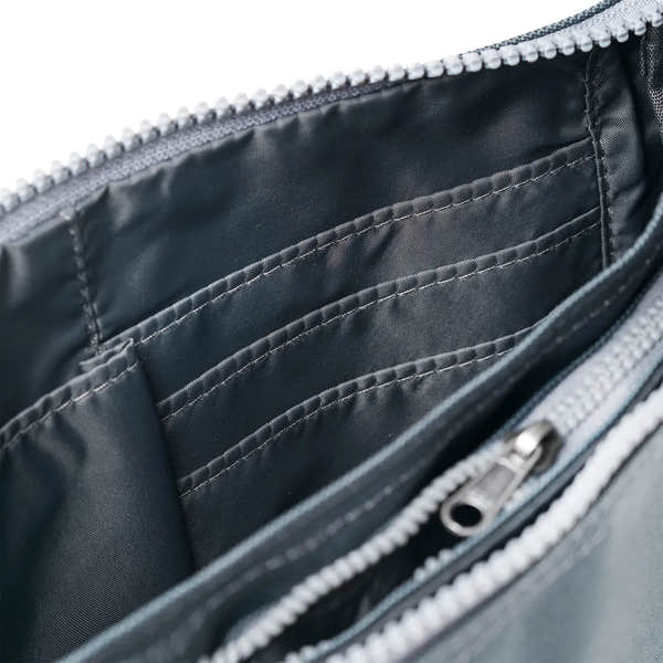 Roka Carnaby Crossbody Smoke XL bag with recycled canvas interior, multiple compartments, and zipper closure.