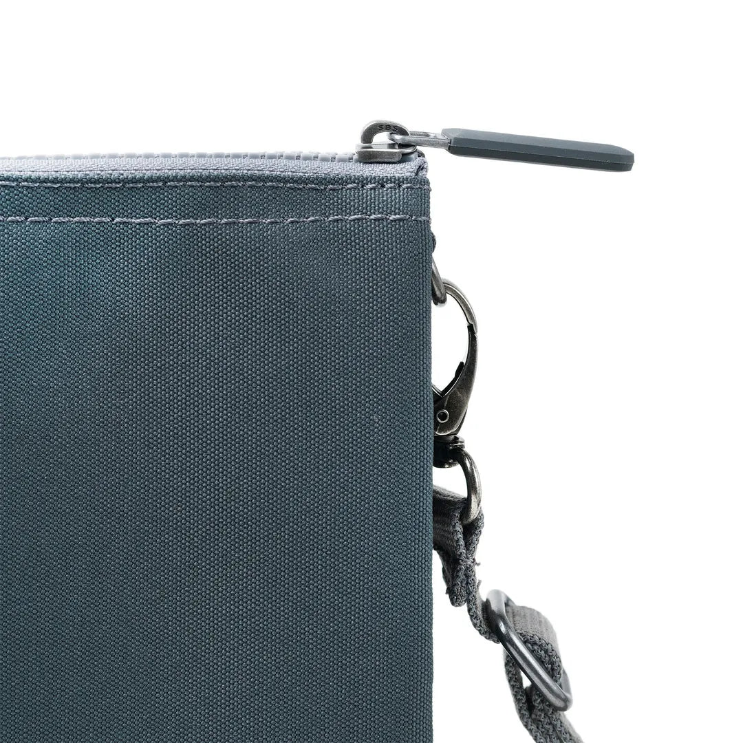 Roka Carnaby Crossbody Bag in Smoke XL recycled canvas with zipper closure and adjustable strap, close-up detail.