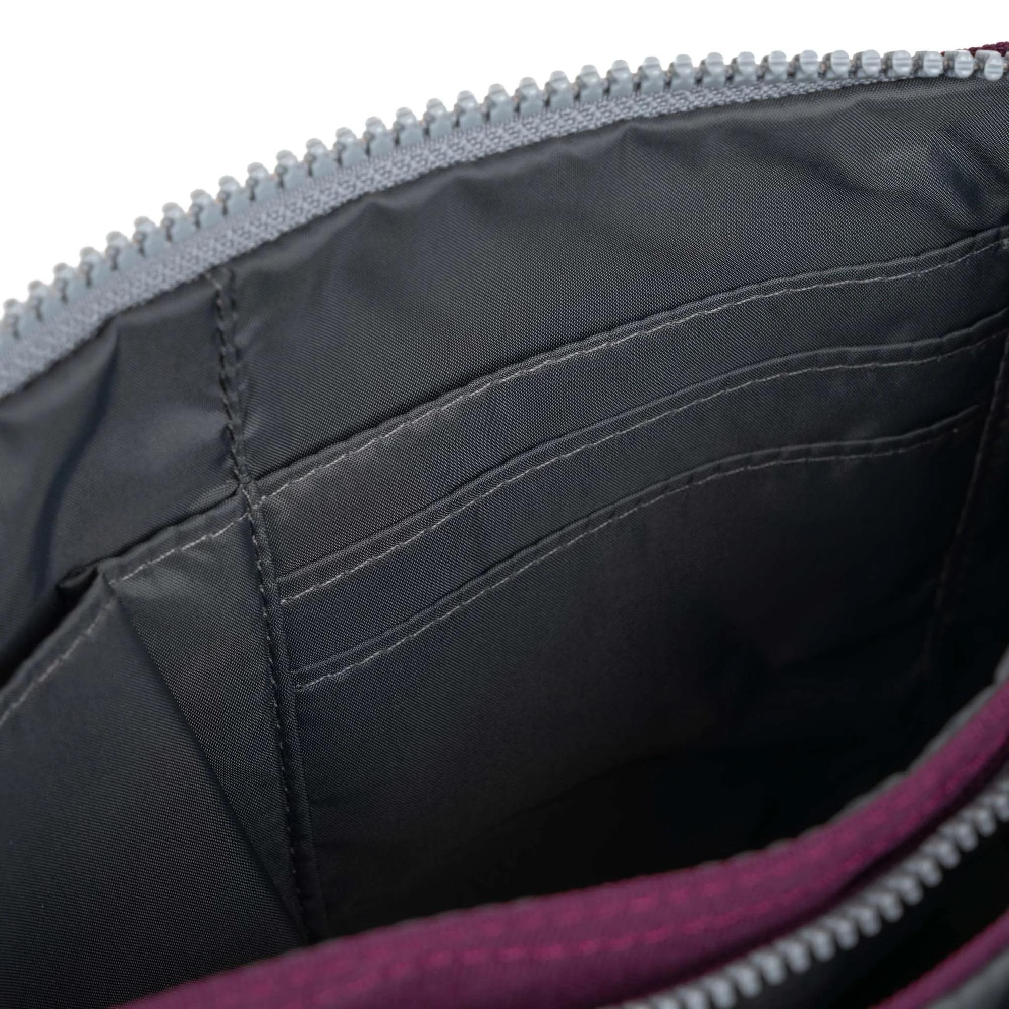 Roka Carnaby Crossbody XL Cherry handbag with recycled canvas, featuring multiple interior card slots and a spacious main compartment.