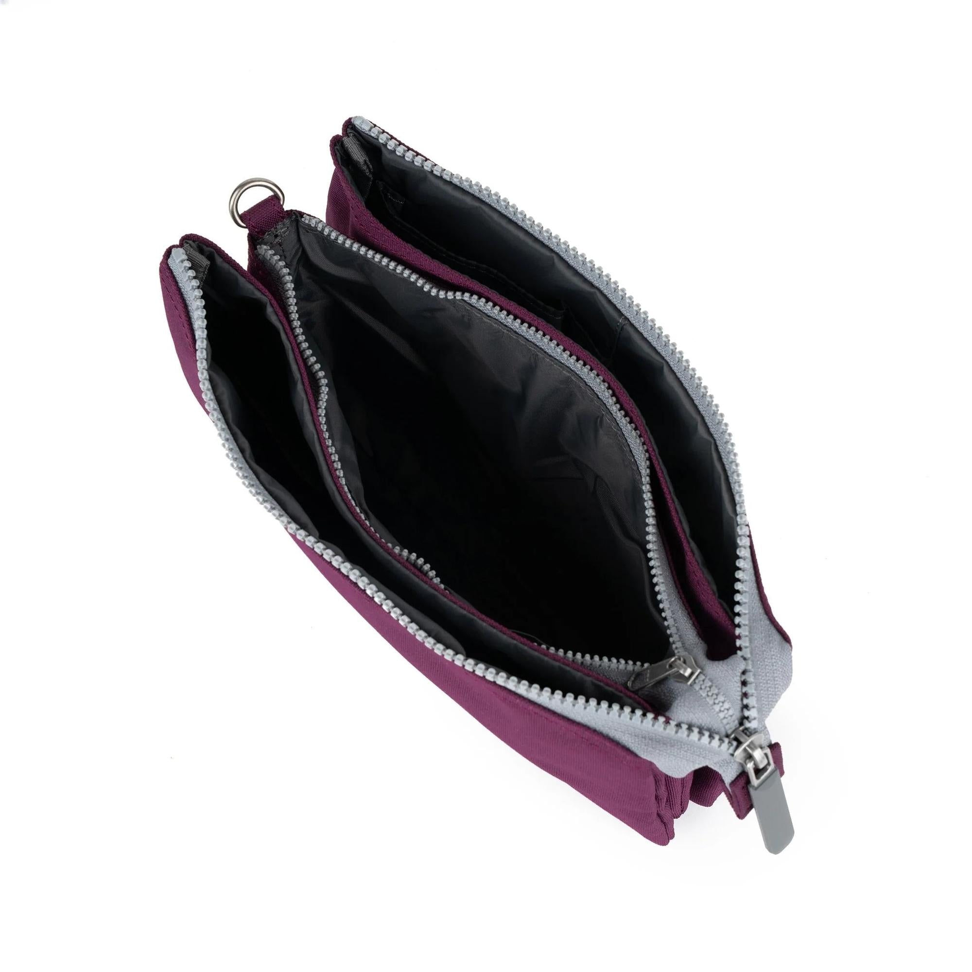 Roka Carnaby Crossbody XL bag with cherry lacquer recycled canvas, spacious interior, multiple compartments, silver zippers, and black lining.