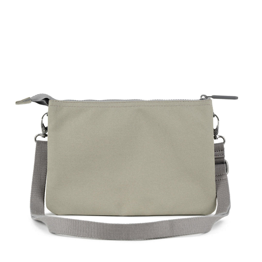 Roka Carnaby Crossbody XL bag in coriander recycled canvas with adjustable gray strap and zip closure.