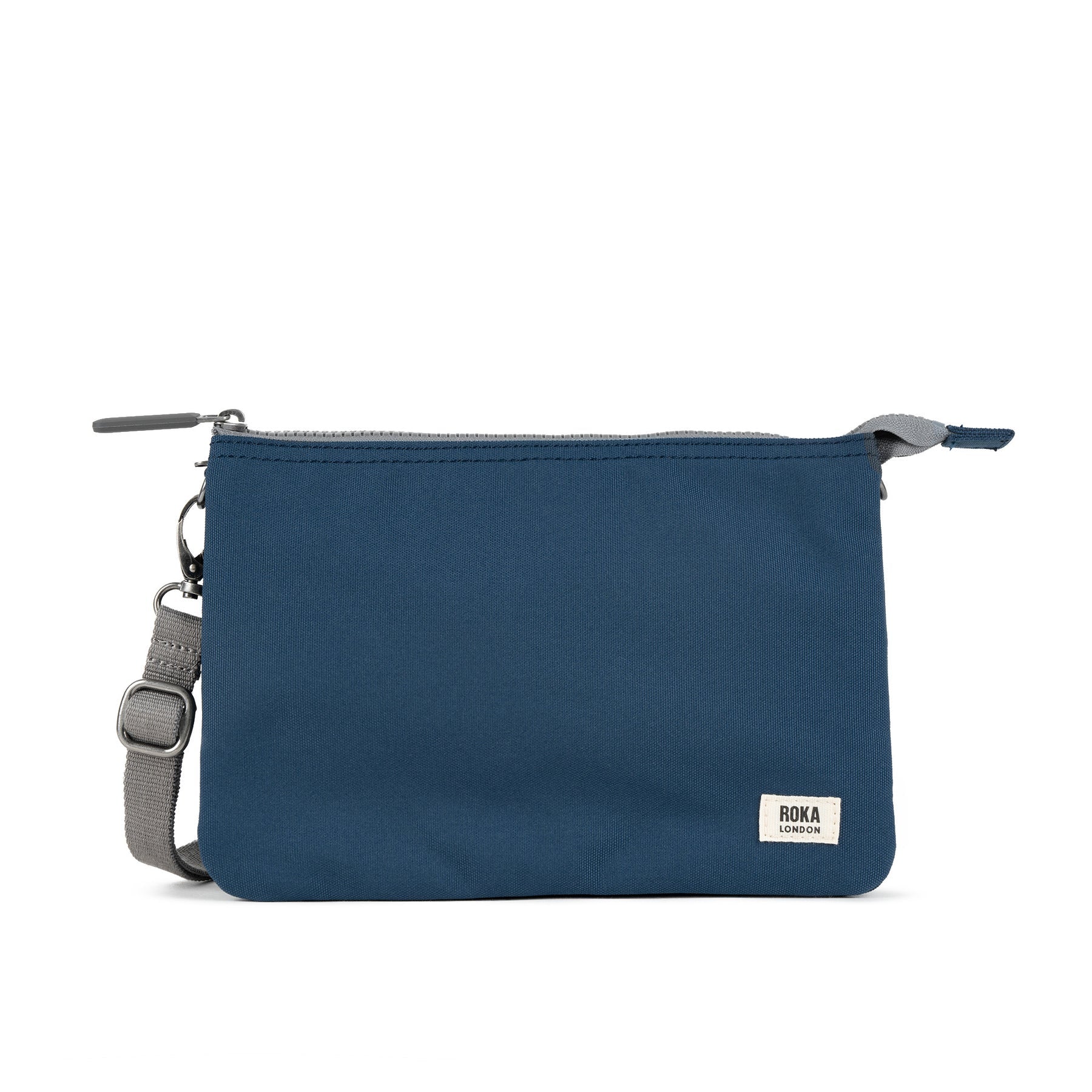 Roka Carnaby Crossbody XL bag in deep blue recycled canvas with adjustable strap and zip closure.