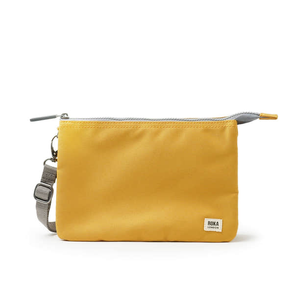 Roka Carnaby Crossbody XL bag in flax-colored recycled canvas with adjustable strap and zip closure.