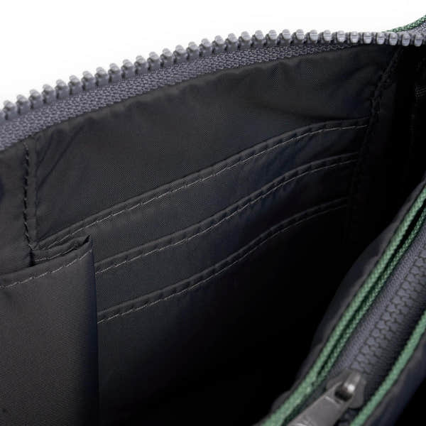 Roka Carnaby Crossbody XL bag in frosted recycled canvas, showing interior with multiple compartments and black lining.