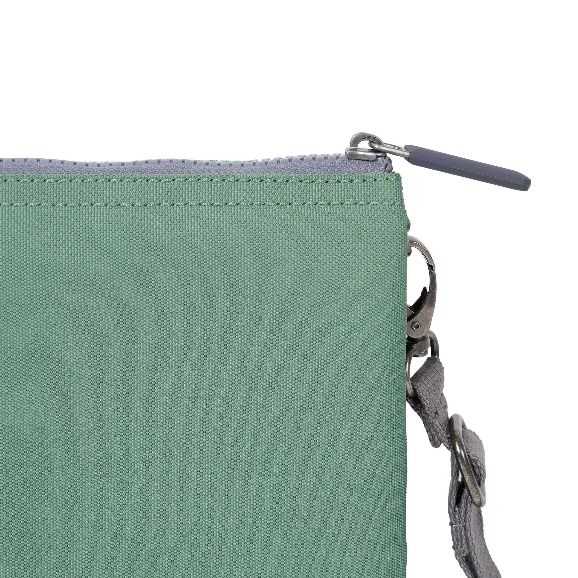 Roka Carnaby Crossbody XL Frost recycled canvas bag with zip closure and adjustable strap, front detail, and metal hardware.