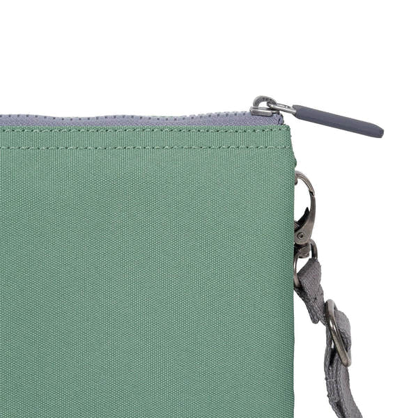 Roka Carnaby Crossbody XL Frost recycled canvas bag with zip closure and adjustable strap, front detail, and metal hardware.