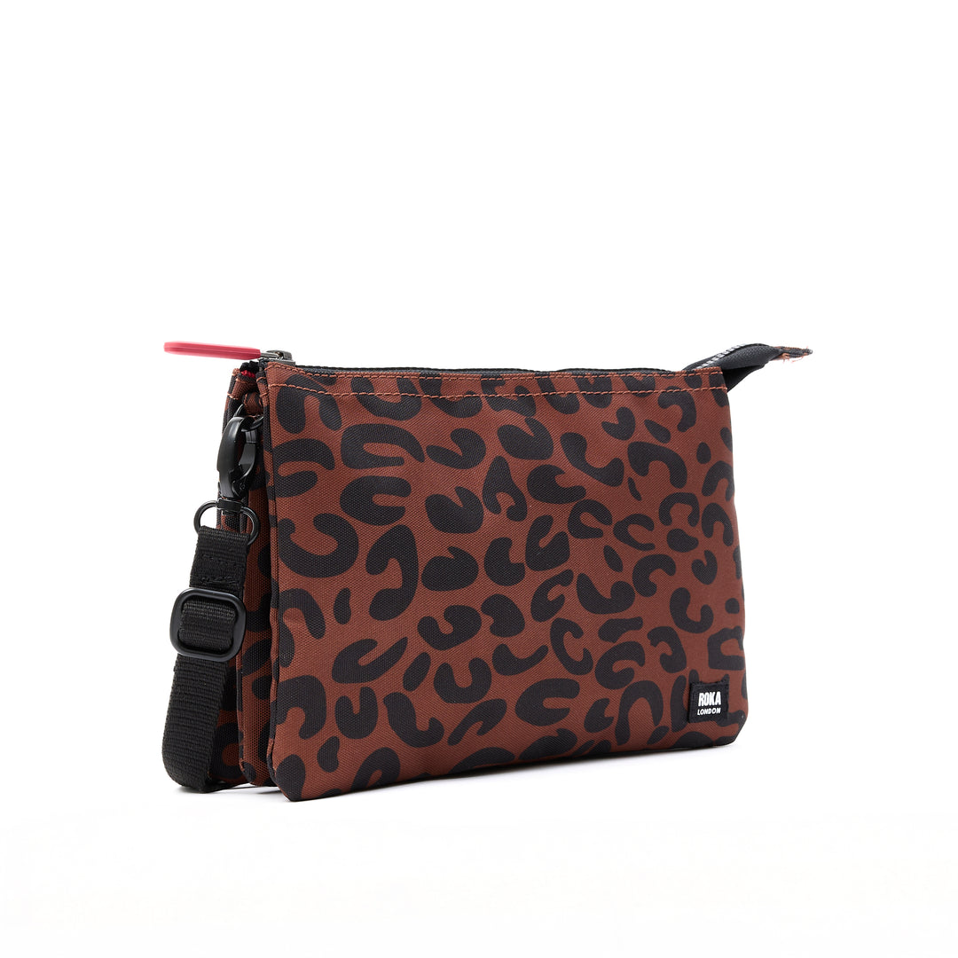 Roka Carnaby Crossbody XL leopard print recycled canvas bag, oversized, stylish, with adjustable strap, black hardware, and logo label.