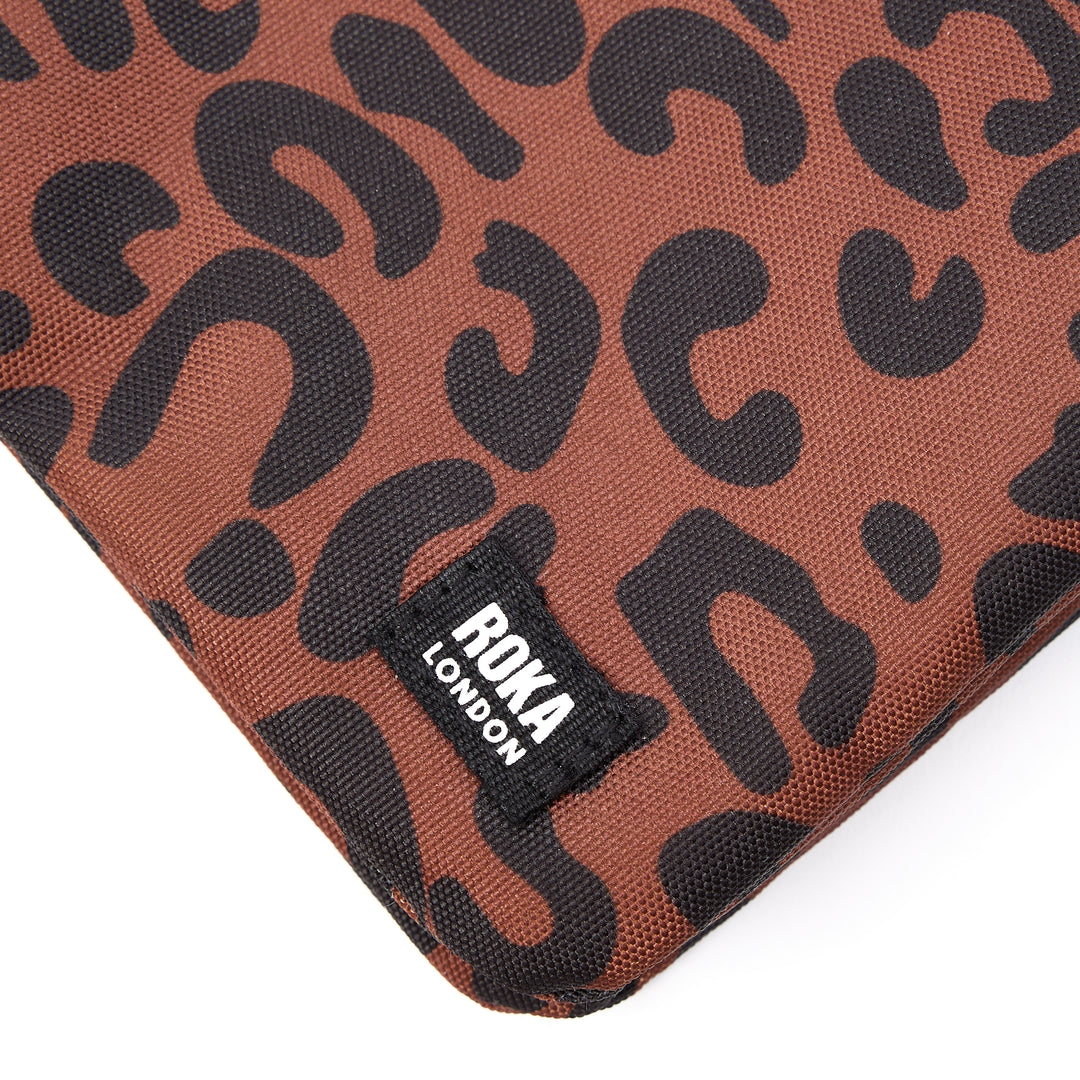 Roka Carnaby Crossbody XL leopard print recycled canvas bag with black logo tag, large size, and bold animal pattern.