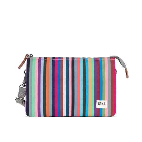 Roka Carnaby Crossbody XL bag with multi-colored stripe recycled canvas, adjustable strap, and zip closure for stylish eco-friendly travel.