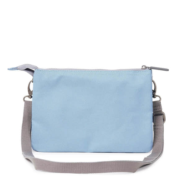 Roka Carnaby Crossbody XL in retro blue recycled canvas, large size with adjustable gray strap and zip closure.