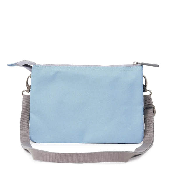 Roka Carnaby Crossbody XL in retro blue recycled canvas, large size with adjustable gray strap and zip closure.