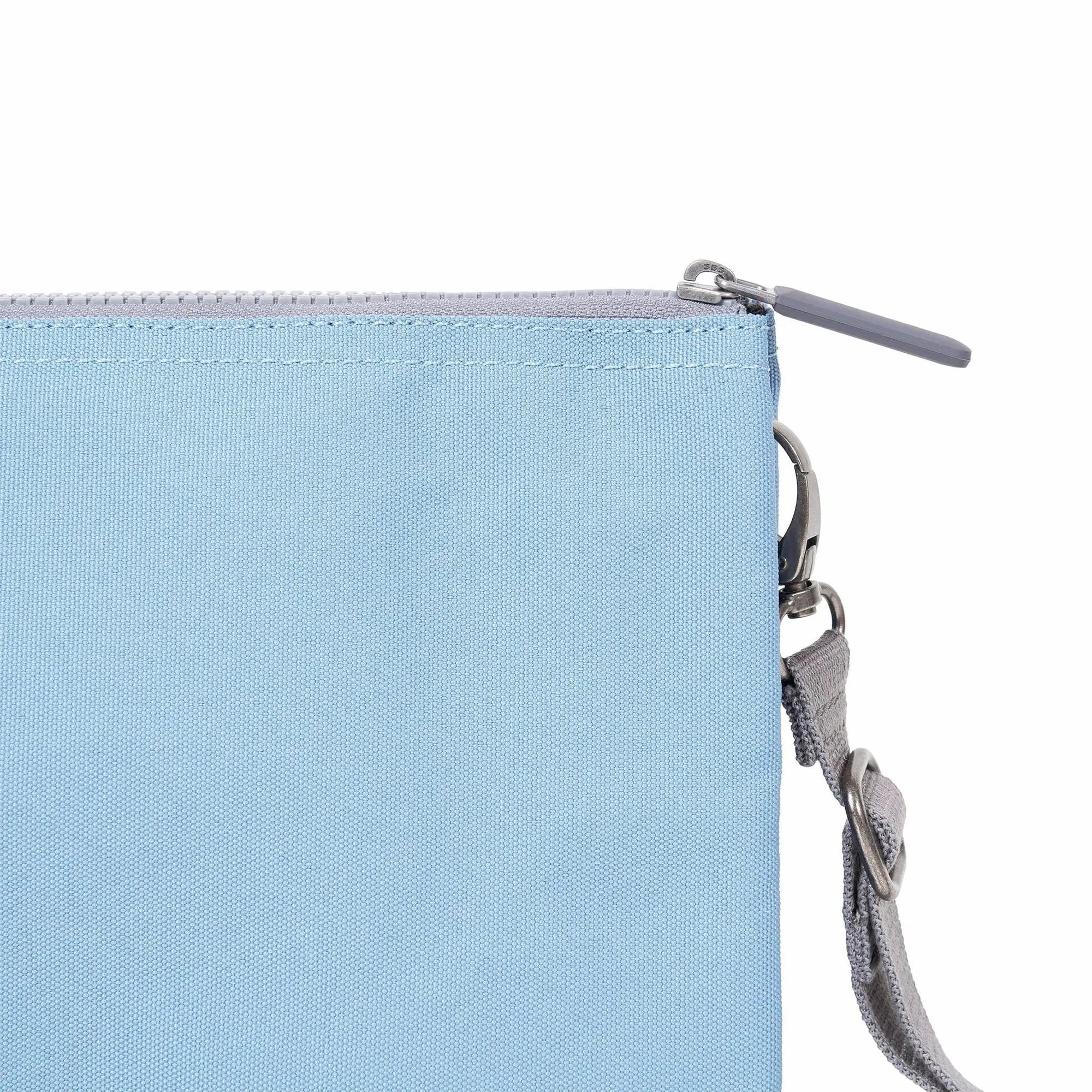 Roka Carnaby Crossbody XL bag in retro blue recycled canvas, with zipper closure and adjustable strap.