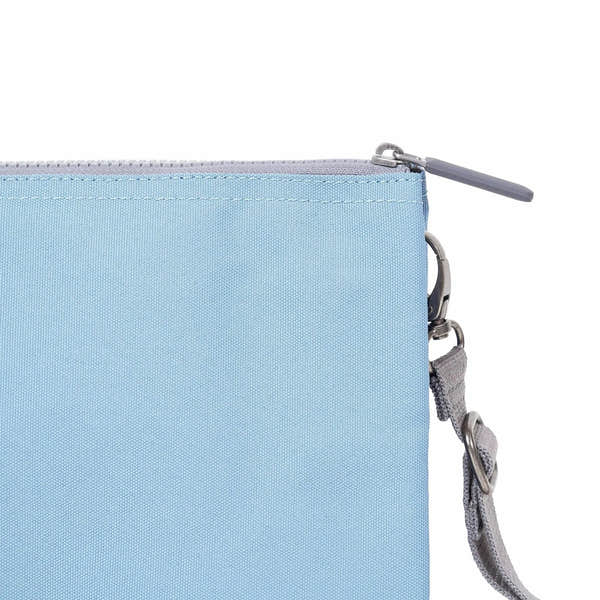 Roka Carnaby Crossbody XL bag in retro blue recycled canvas, with zipper closure and adjustable strap.