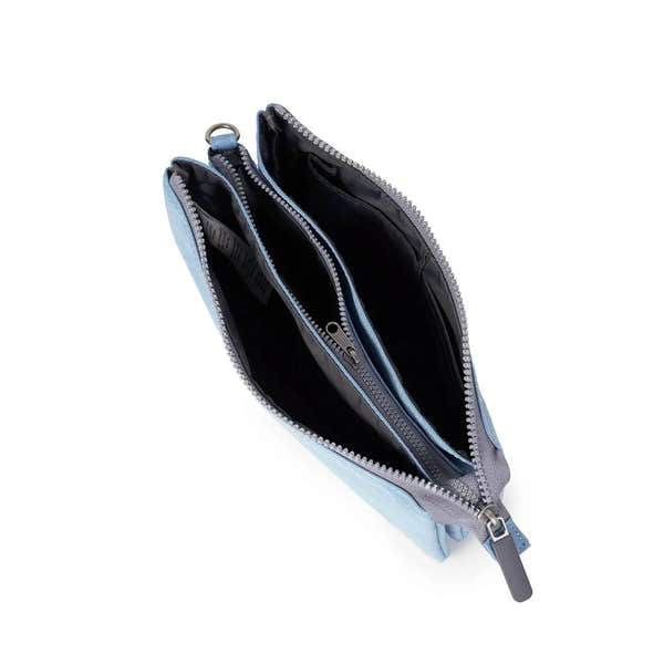 Roka Carnaby Crossbody XL in retro blue recycled canvas, showing open interior with multiple compartments and zippered pockets.
