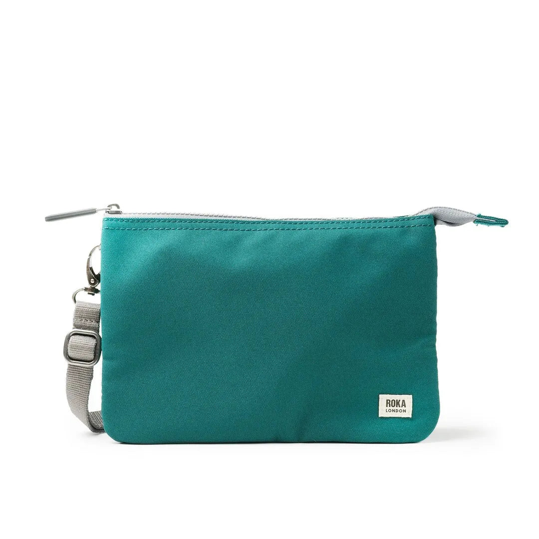Roka Carnaby Crossbody XL Teal Recycled Canvas bag with adjustable strap and silver hardware, ideal for eco-friendly daily use.