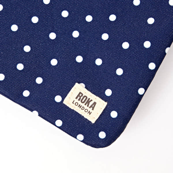 Roka Carnaby XL Navy Polka Dot Recycled Canvas Crossbody Bag, brand label detail.