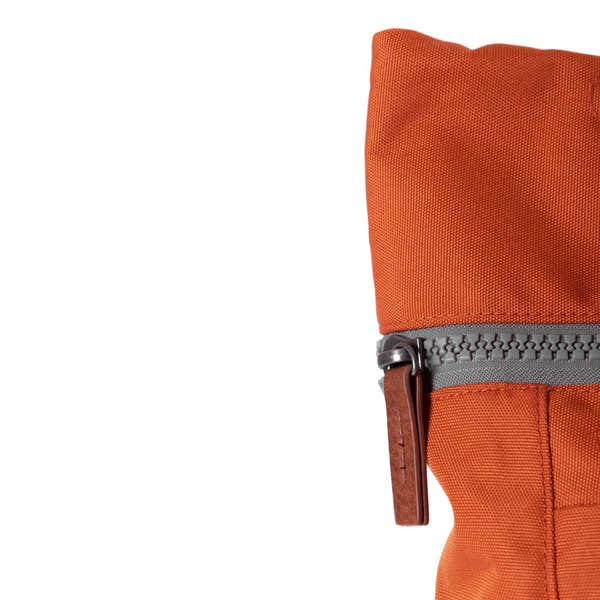 Roka Finchley A Atomic Orange Recycled Canvas backpack featuring durable fabric and grey zipper with leather pull tab.
