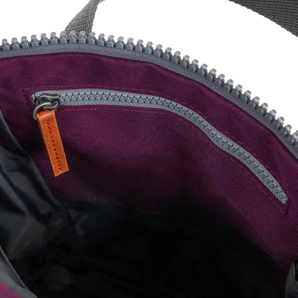 Interior view of Roka Finchley A Cherry Lacquer Recycled Canvas bag with purple lining and grey zipper pocket.