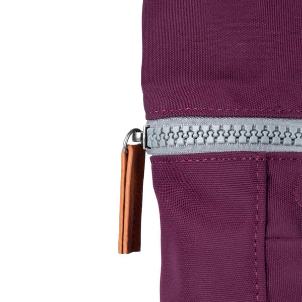 Roka Finchley A Cherry Lacquer Recycled Canvas backpack with silver zipper and leather pull tab, in cherry red color.