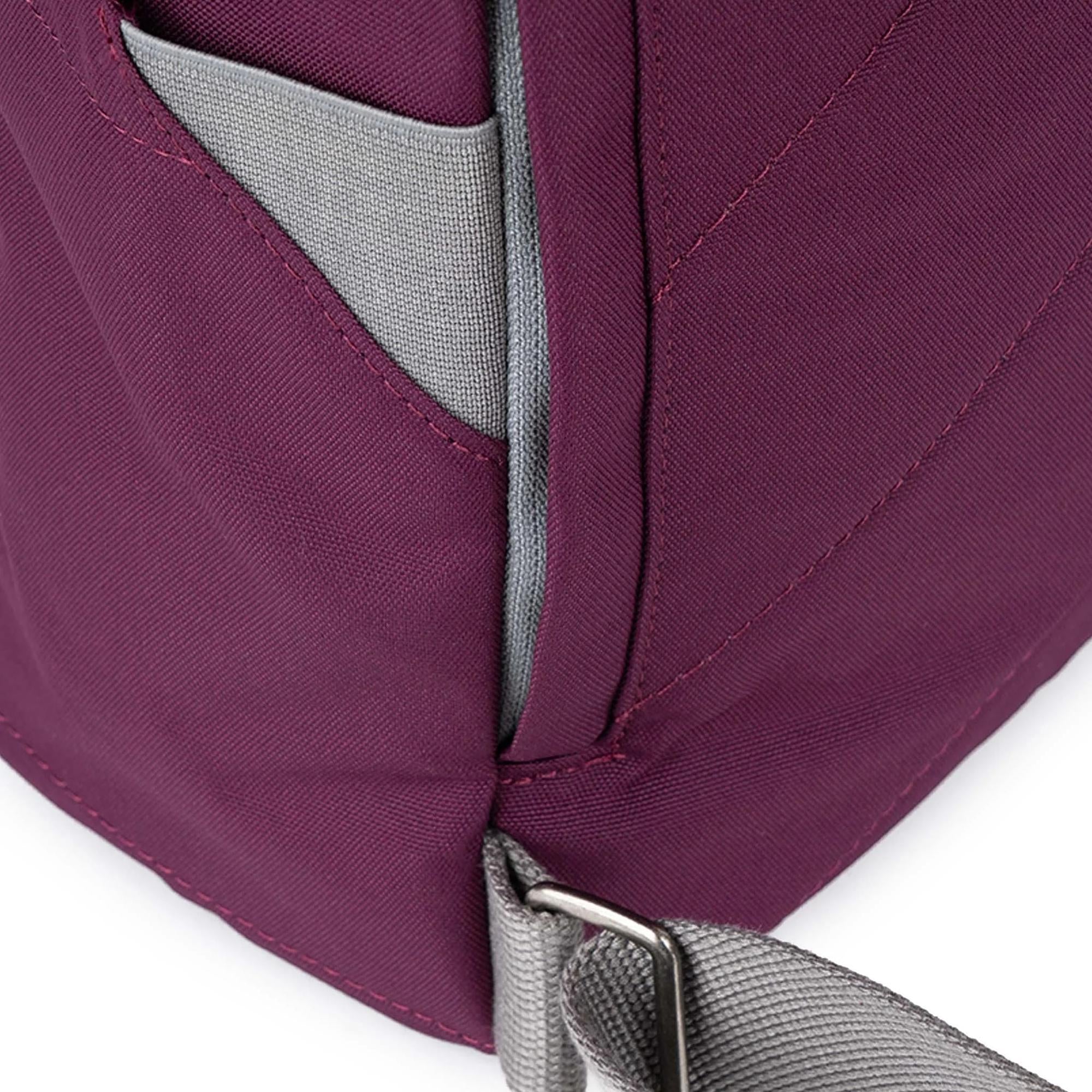 Roka Finchley A Cherry Lacquer Recycled Canvas backpack with grey accents and adjustable strap.