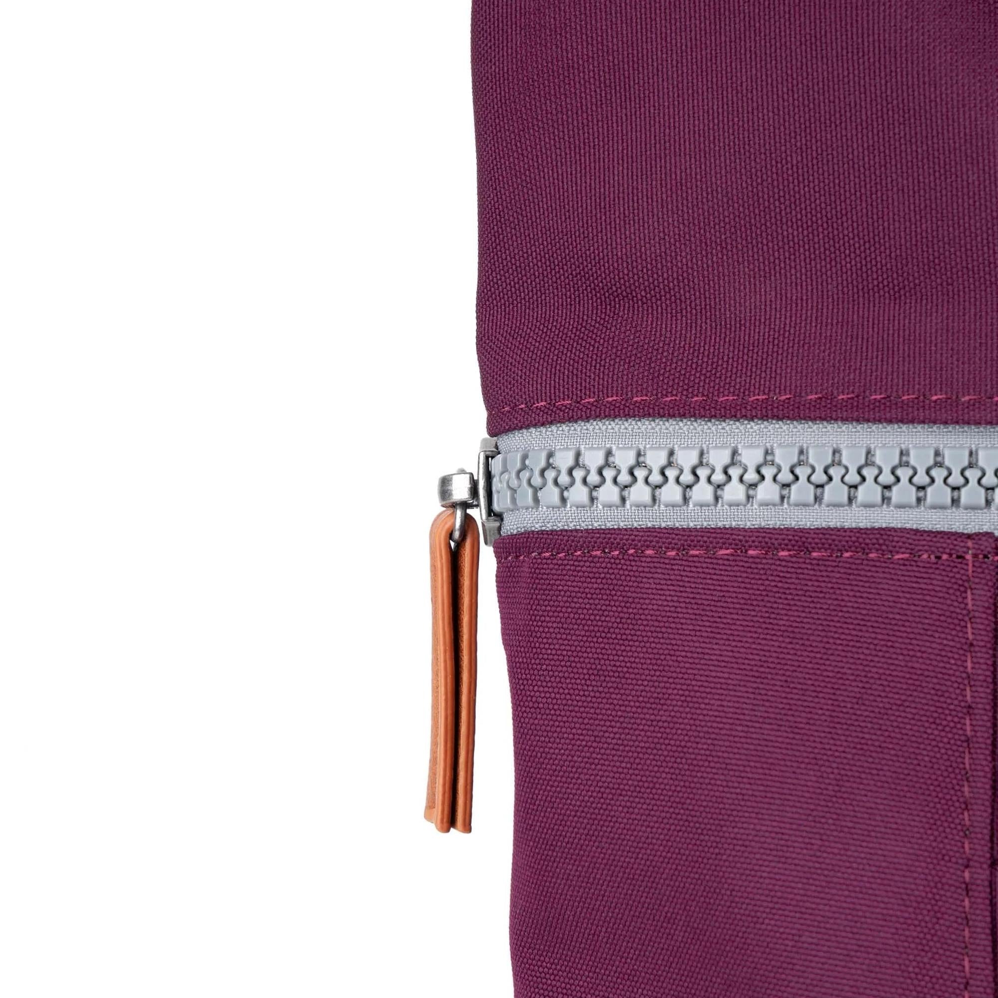 Roka Finchley cherry lacquered recycled canvas bag with silver zipper and tan leather pull tab.