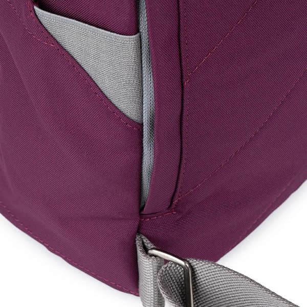 Roka Finchley Cherry Lacquer Recycled Canvas backpack with gray strap, close-up of fabric and stitching detail.