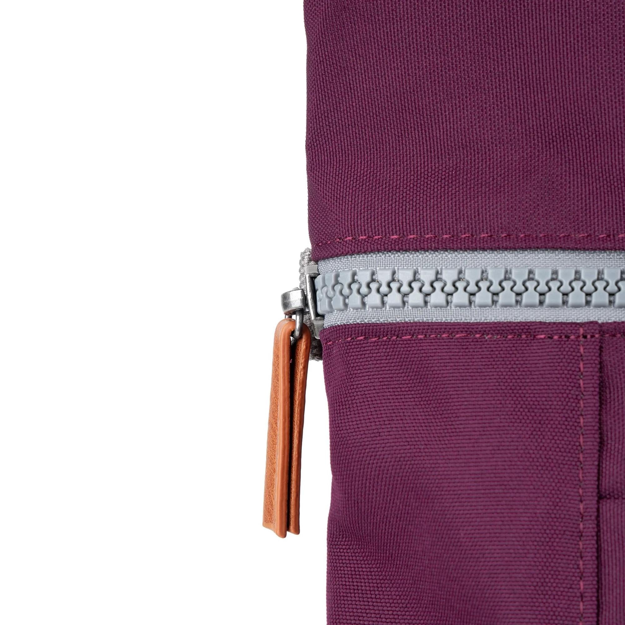 Roka Finchley A Cherry Lacquer Recycled Canvas bag close-up, featuring silver zipper and leather pull tab, in cherry red color.