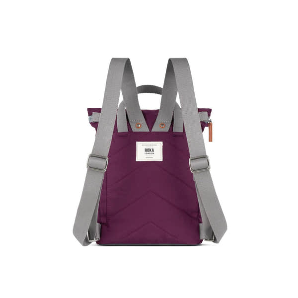 Roka Finchley backpack in cherry lacquer recycled canvas with gray straps, front patch logo, and zip closure, stylish and eco-friendly.
