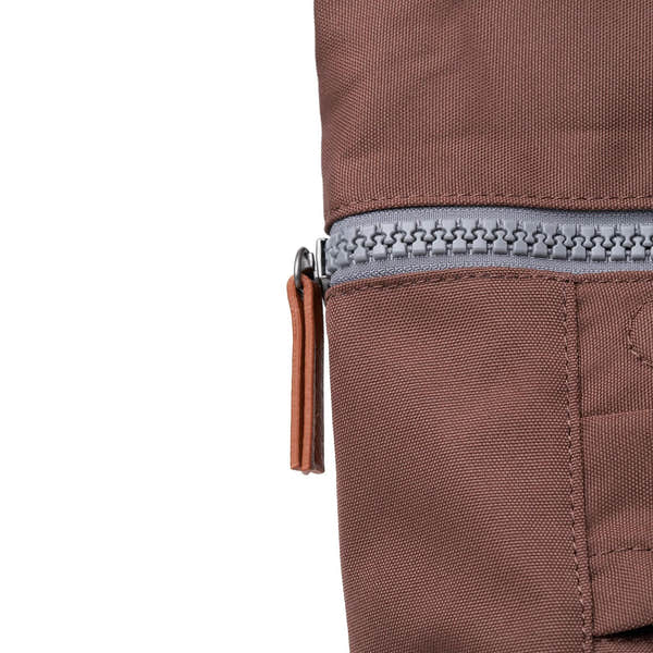 Roka Finchley A Coco recycled canvas backpack with zip closure, brown fabric, and leather zipper pull.